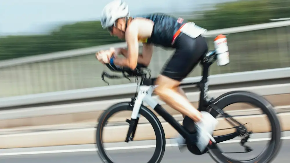 Triathlete in the aero position on a time trial bike